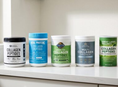 Five collagen powder tubs on a kitchen counter: Sports Research, Vital Proteins, Garden of Life, Ancient Nutrition and Great Lakes